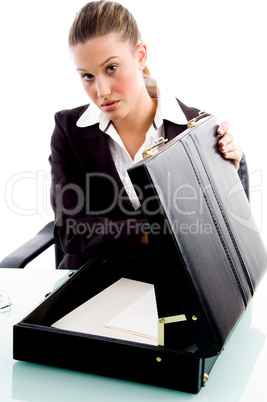 businesswoman putting document in briefcase