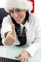 woman with christmas hat and thumbs up