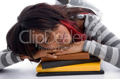 tired school girl sleeping with her books