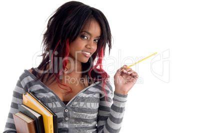school girl posing with pencil and books
