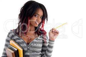 school girl posing with pencil and books