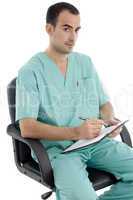 sitting doctor writing on notepad