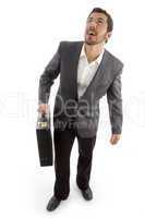 successful attorney holding office bag and looking upwards