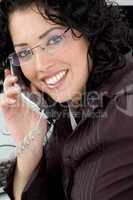 close up of smiling woman talking on phone