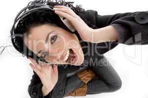 high angle view of smiling woman holding headphone