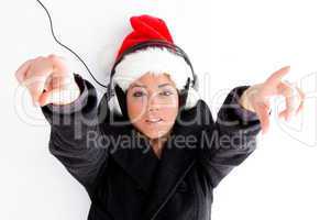 christmas hat wearing female pointing with both fingers