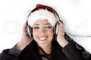 happy female listening music and wearing christmas hat