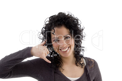 smiling female showing telephone gesture