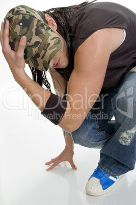 sitting young male holding cap