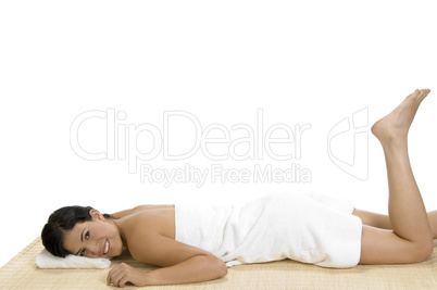 pleased woman laying on bamboo mat