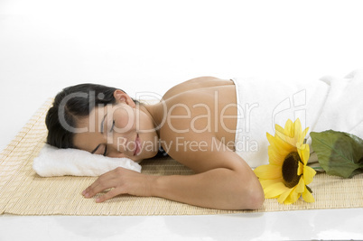 female sleeping on mat with sunflower