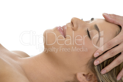 portrait of sleeping female getting head massage