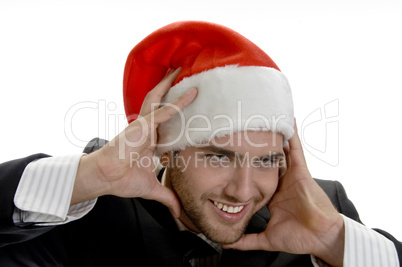 man posing with santa cap and holding his face