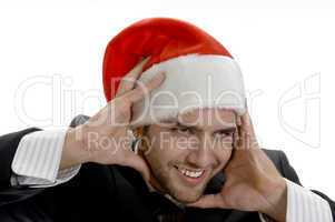 man posing with santa cap and holding his face
