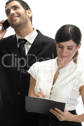 man busy with phone call and female making notes