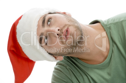 man with santa cap and looking upward