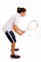 side view of man playing tennis