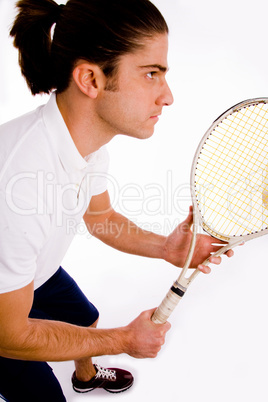 side pose of player carrying racket