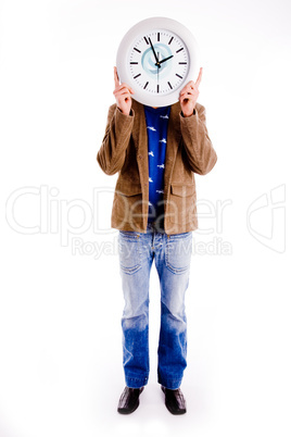 front view of man hiding his face with watch