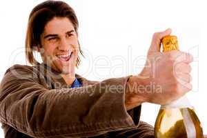 portrait of man holding champagne bottle