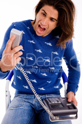 front view of angry man shouting on phone