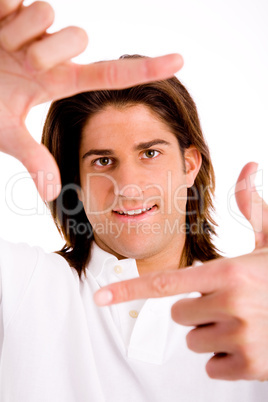 portrait of man showing framing hand gesture