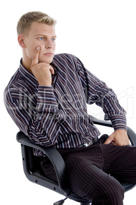 young caucasian sitting on chair thinking