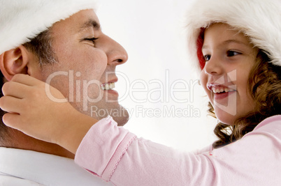 girl pulling father's ears