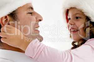 girl pulling father's ears
