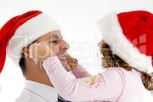 daughter stretching father's cheeks