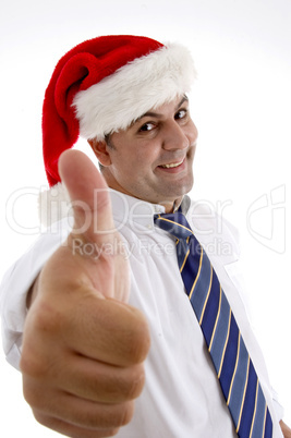 businessman with christmas hat showing approval sign
