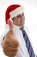 businessman with christmas hat showing approval sign