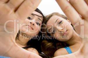 girls showing framing gesture