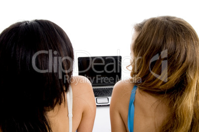 back pose of female students with laptop