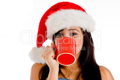 girl drinking coffee wearing christmas hat