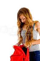 young woman looking in her bag