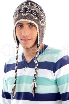 portrait of young boy covering his head with woolen cap