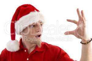 christmas hat wearing male looking at palm