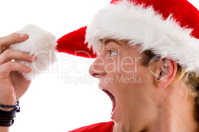 shouting male looking at his christmas hat