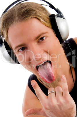 close up of man listing music and showing tongue