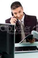 front view of smiling businessman busy on phone