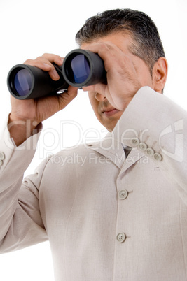 side view of ceo looking through binocular