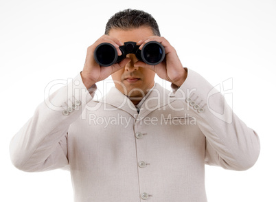 front view of businessman looking through binocular