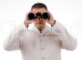 front view of businessman looking through binocular