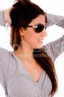 portrait of smiling female with sunglasses holding her hair