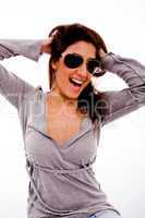 portrait of smiling woman with sunglasses holding her hair