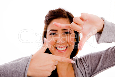 portrait of smiling woman showing framing gesture