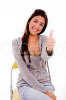 side view of smiling woman showing thumb up