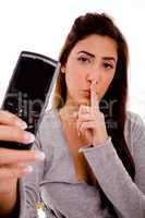 portrait of woman with cell phone instructing to be silent
