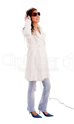 side pose of standing model listening music